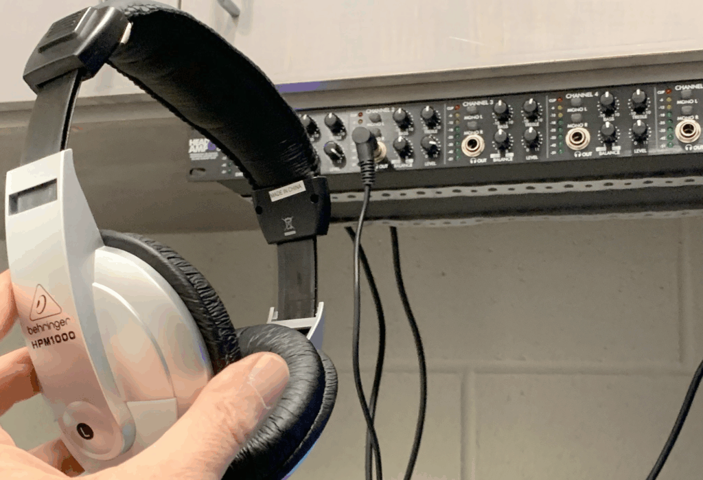 This is an image of someone holding a pair of headphones. 