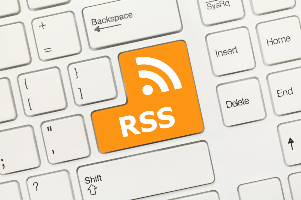 This is a white keyboard with an orange key that says RSS on it and has the RSS logo.
