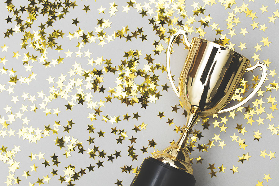 Tropy_Confetti Photo of a trophy on a table surrounded by gold stars
