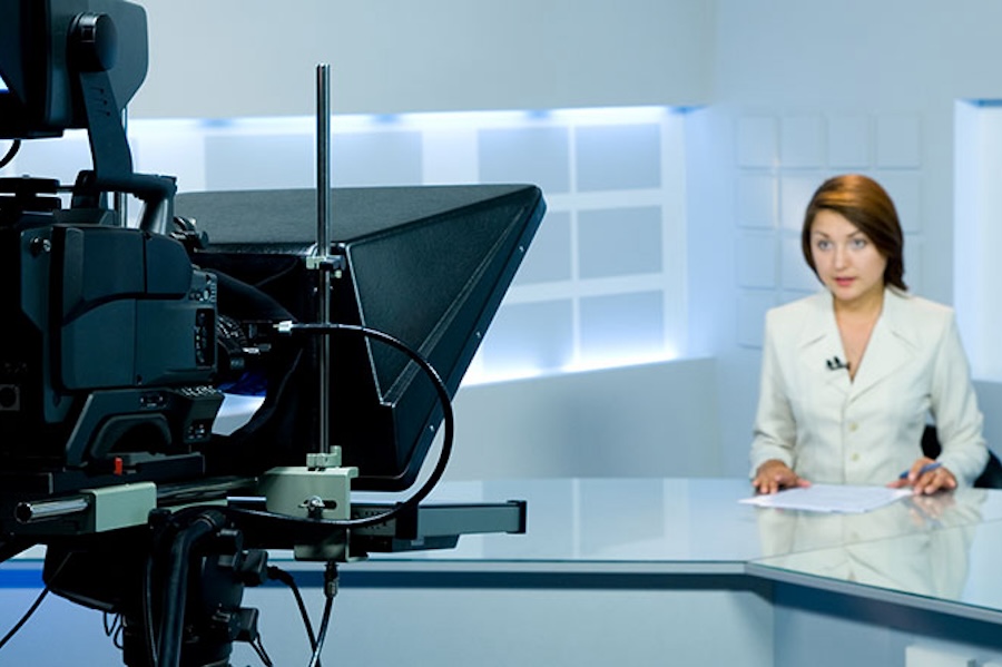 Photo of a woman hosting a news broadcast