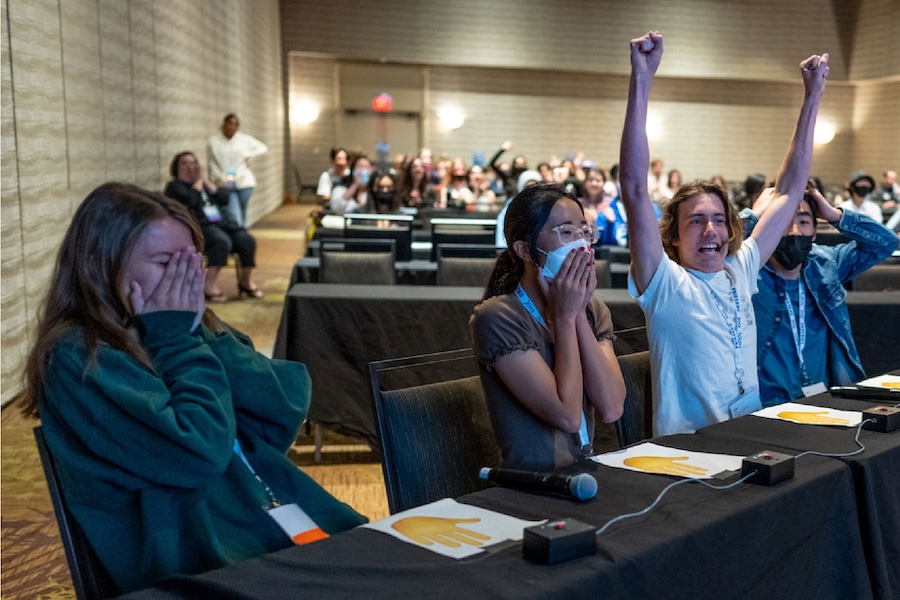 Photo of 4 students celebrating after winning Quiz Bowl