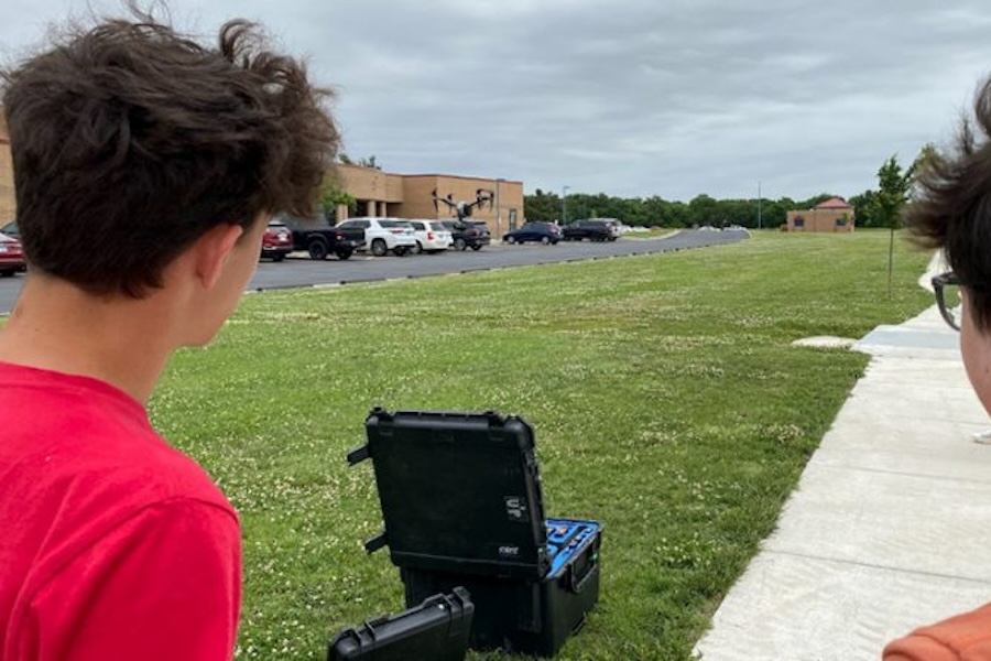 Photo of two boys using a drone