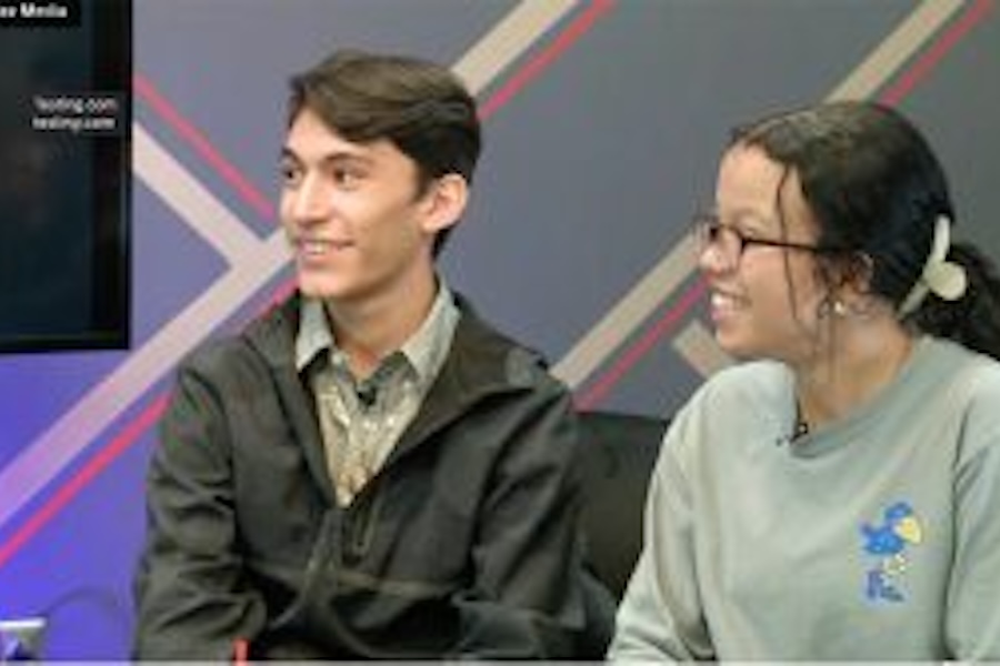 Image of two people hosting a podcast