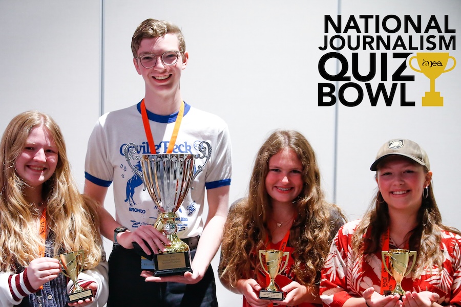 4 students show off trophies after winning the National Journalism Quiz Bowl, trophy icon in the top right corner