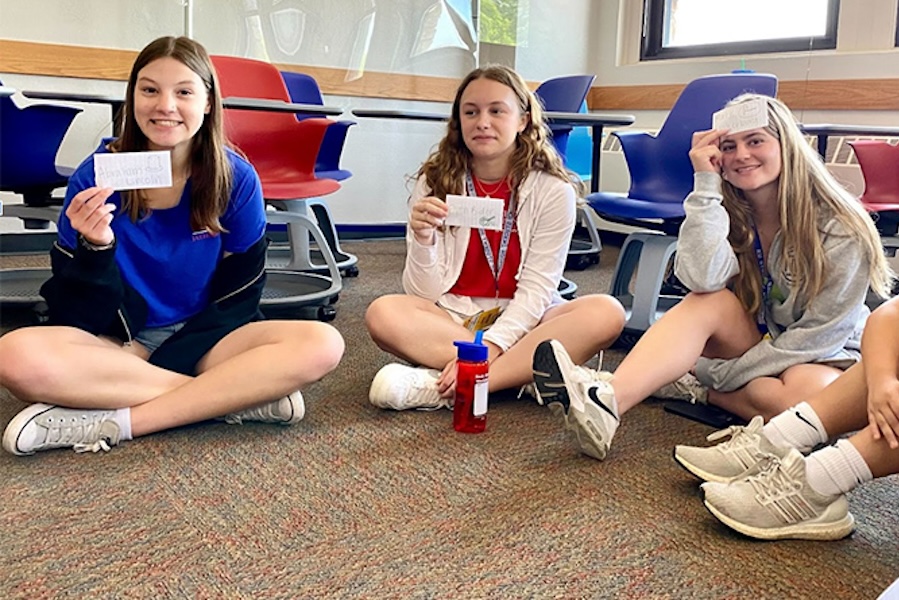 SD 3 girls play a game in a circle with notecards
