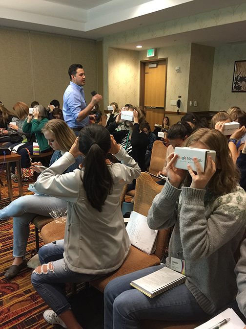 Photo of students using hand-made VR headsets during a presentation