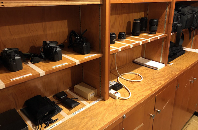 Photo of a camera equipment setup on a wooden dresser type table