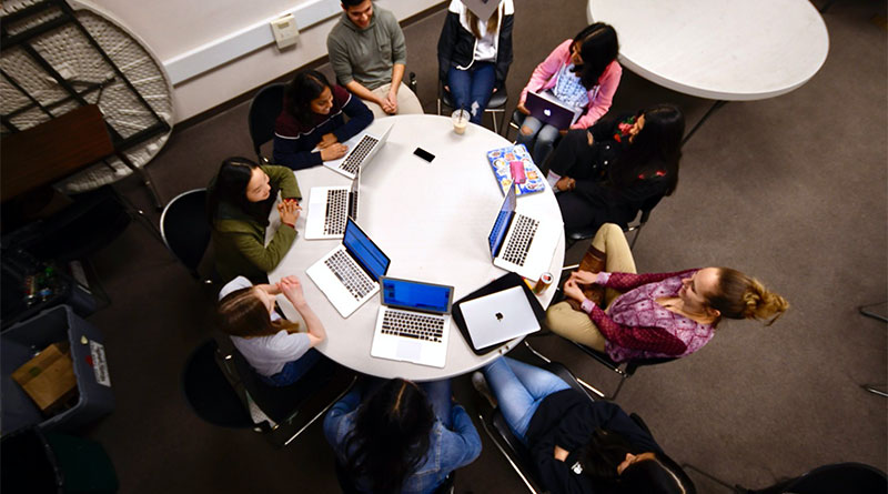 Overhead shot of a group of students on computer working around a table