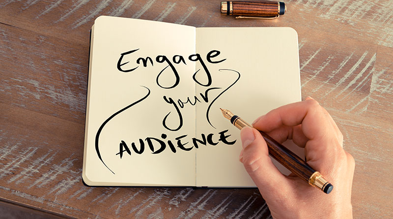 Someone writes Engage your Audience on a piece of paper