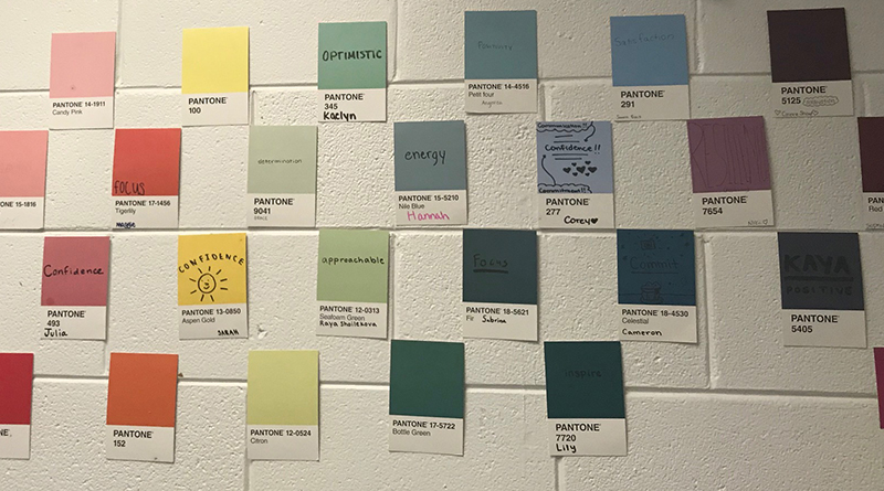 Photo of a paint swatches on a wall with positive affirmations written in the colors