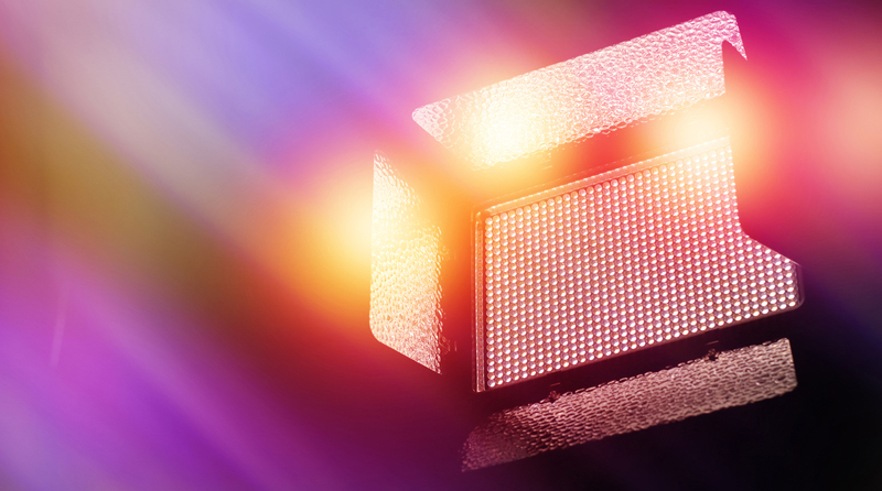 Picture of a camera light with purple and red lights around it