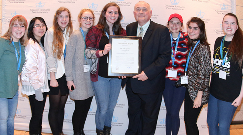 Group Photo of students holding a Gold Crown Award plaque