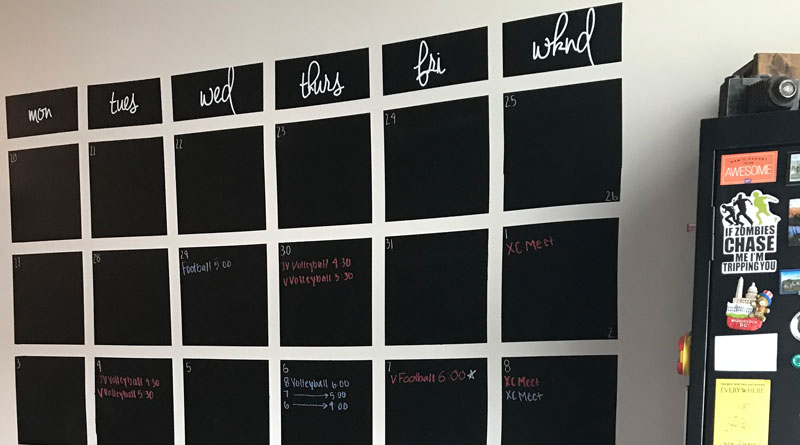 Photo of a handmade calendar that has event scheduled on a wall