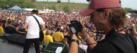Photo of someone taking a photo of a concert