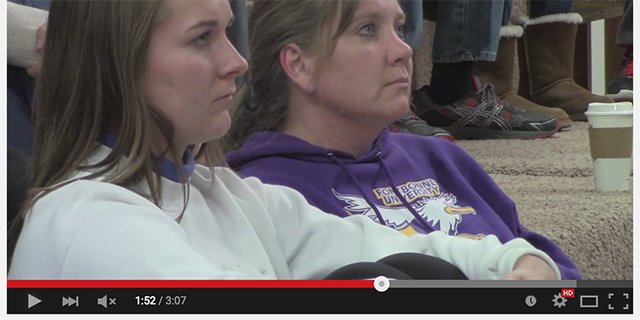 Screenshot from a video of two people watching a game