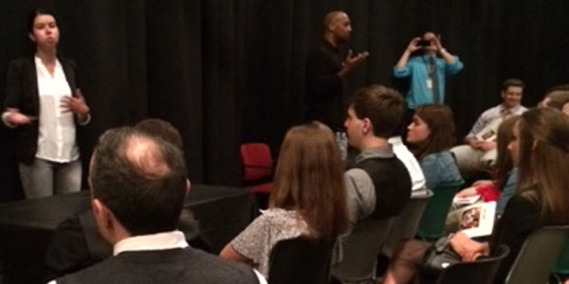 Photo of students watching a panel of adults