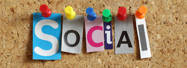Graphic of tacs holding up words that spell socials on a corkboard