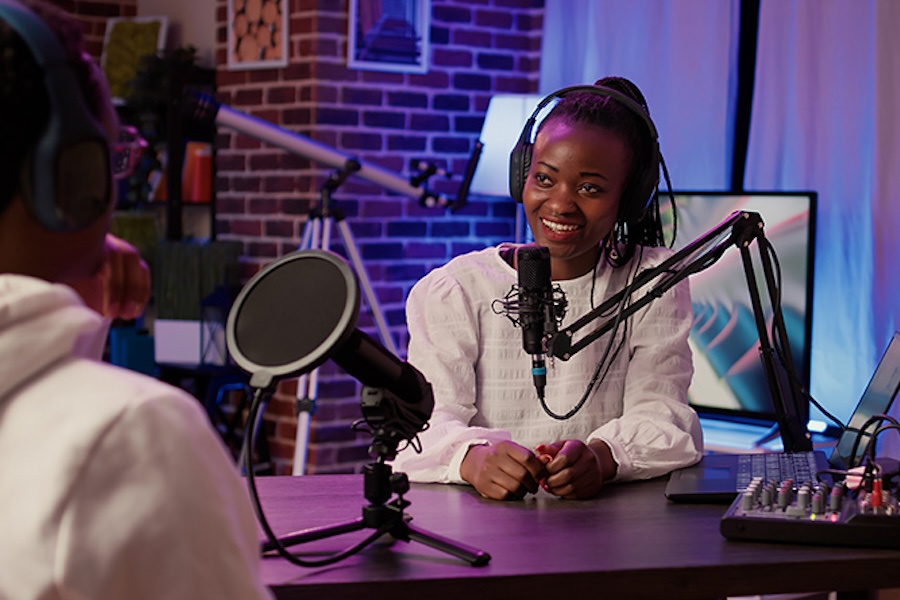 A women records a podcast with a guest