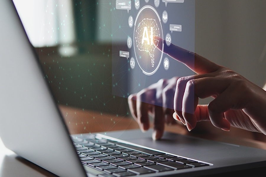 Photo of someone selecting a 3D AI icon that is hovering over a computer screen
