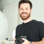 benjamin campbell smiling and holding a camera