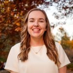emma kinney headshot in front of a fall tree