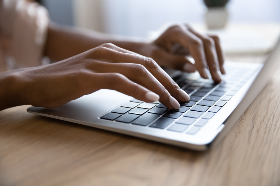 This is a photo of a person's hands typing on a keyboard.