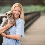 leslie fireman smiling and holding a small dog
