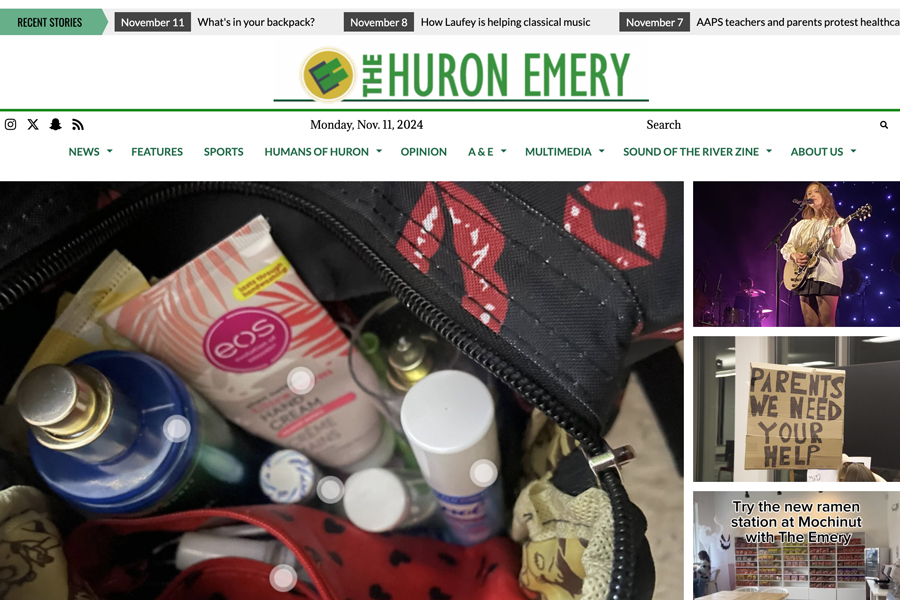 This is a website homepage that says The Huron Emery at the top and has four pictures, the main one is of the inside of a purse.