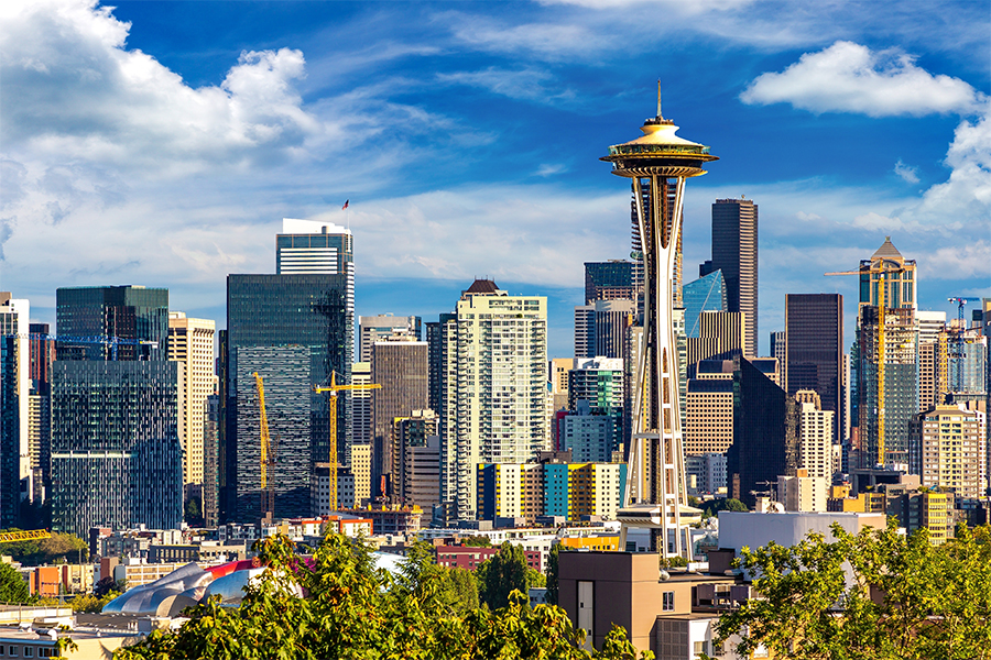 This is a photo of the Seattle city skyline. There are many buildings and the Space Needle building is off centered on the right.