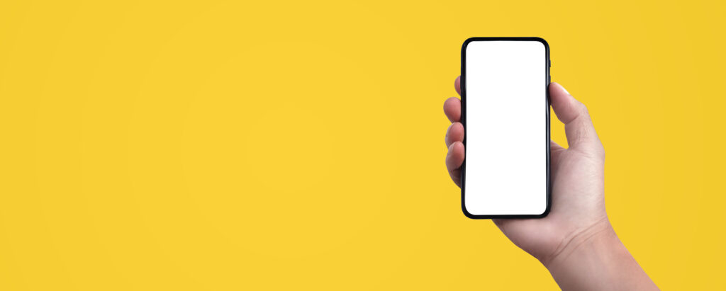 This is a hand holding a blank phone on a yellow background.