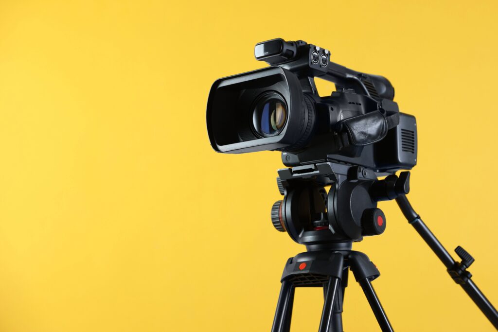 This is a video camera on a yellow background.