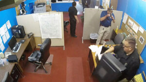 Image shows police raiding the Marion County Record news room.